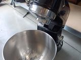 a large metal bowl with a whisk inside of it