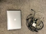 a laptop and headphones on the floor next to a laptop computer