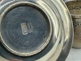 a silver cup and a silver cup on a table