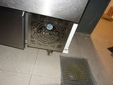 tiled floor in a kitchen with a metal grate on the floor