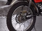 a red dirt bike parked on the side of the road
