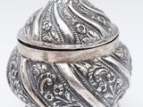 an ornate silver box with a bird on top of it
