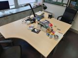 a desk with a computer and a chair in an office