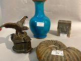 a blue vase, a blue vase, and a blue vase on a table