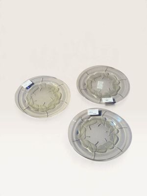 three pieces of glass sitting on top of a table next to each other