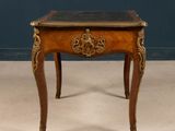 a small wooden table with a marble top on it