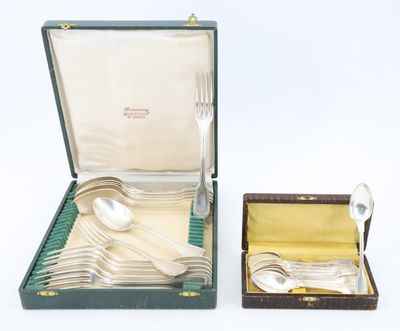 silverware in a case with a spoon and spoon rest in it