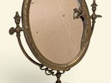 an image of a mirror on a stand with a bird on it