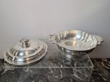 pair of silver plated serving dishes on a marble counter top