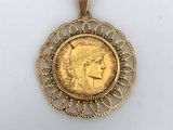 a gold coin with a woman ' s face in the center of it