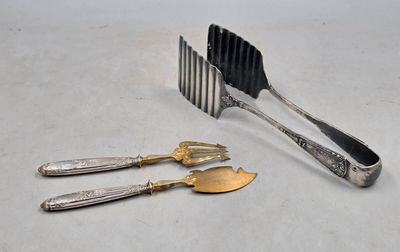 three forks and a knife on a white table