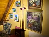 a room with a bed and pictures on the wall