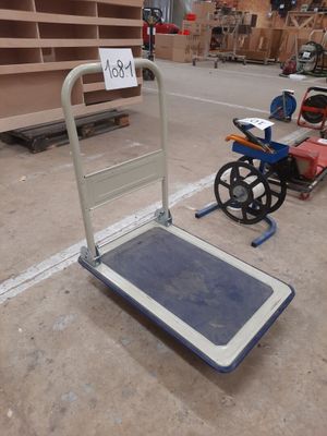 a dolly with a sign on it in a warehouse