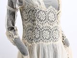 an image of a mannequin wearing a white dress with a lace overlay