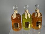 three bottles of liquor sitting on top of a clear table