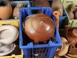 many different types of pots and vases in the bins