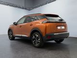 the rear end of an orange suv parked in a garage