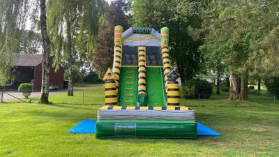 a inflatable slide in the middle of the grass