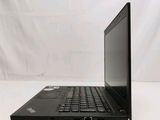 the back of a laptop computer sitting on top of a white table
