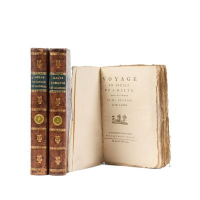 two books sitting next to each other on a white surface