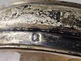 a close up of a silver plate with a crystal in it