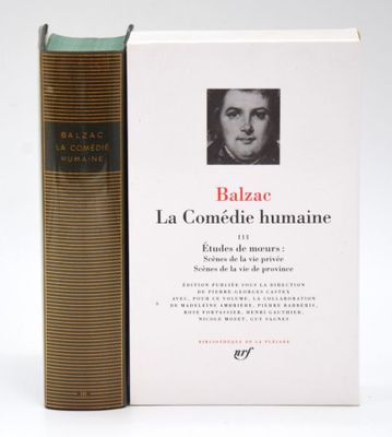 the book is sitting next to a book with a picture of a man ' s face on it