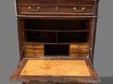 un vieux bureau en bois muni de tiroirs, avec un tiroir en dessous