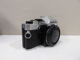a black and silver camera sitting on a white table