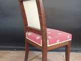 a wooden chair with a pink upholstered seat