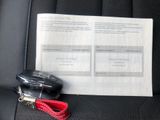 a picture of a car seat with a car key and a receipt
