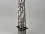 a large stone obel with a black base on a white background