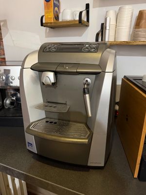 a coffee machine sitting on a counter in a kitchen