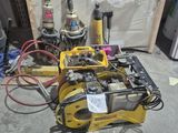 many tools that are sitting on the floor in the garage