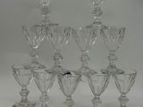 six clear glass goblets are stacked on top of each other
