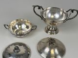 four pieces of silverware including a bowl, saucer, and spoon