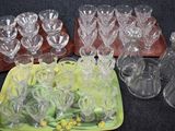 a lot of empty wine glasses and a tray of empty wine glasses