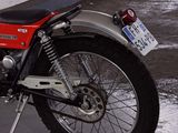 a red and black motorcycle parked in a parking lot