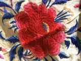 an image of a close up of a red flower on a white cloth