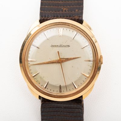 a close up of a watch on a white surface
