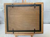an old wooden easel with a black frame on a white background