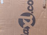 a cardboard box with a logo on it sitting on the floor