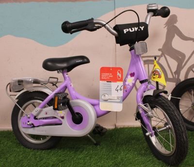 a purple bike that is parked in front of a wall