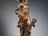 an image of a bronze statue of a woman with a dog