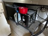 a red bucket sitting on top of a stove
