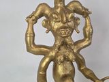brass figurine of a man with a snake on his head