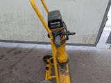 a yellow hand truck with a yellow handle on the street
