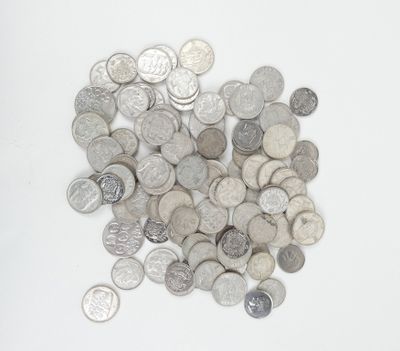 a pile of silver and silver coins on a white surface