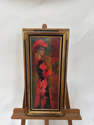 tableau représentant une femme coiffée d'un chapeau rouge, posé sur un chevalet en bois