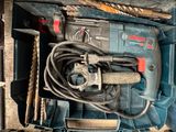 a blue tool box filled with tools like drill, hammers, and other tools