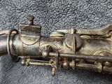 a silver saxophone that is laying on the ground